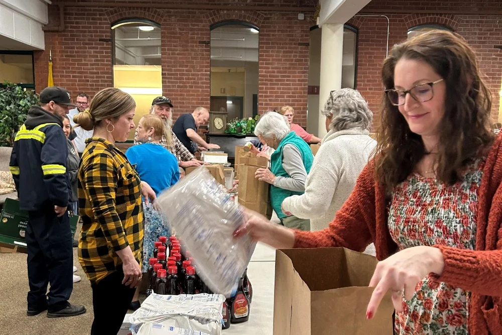 people filling brown food bags