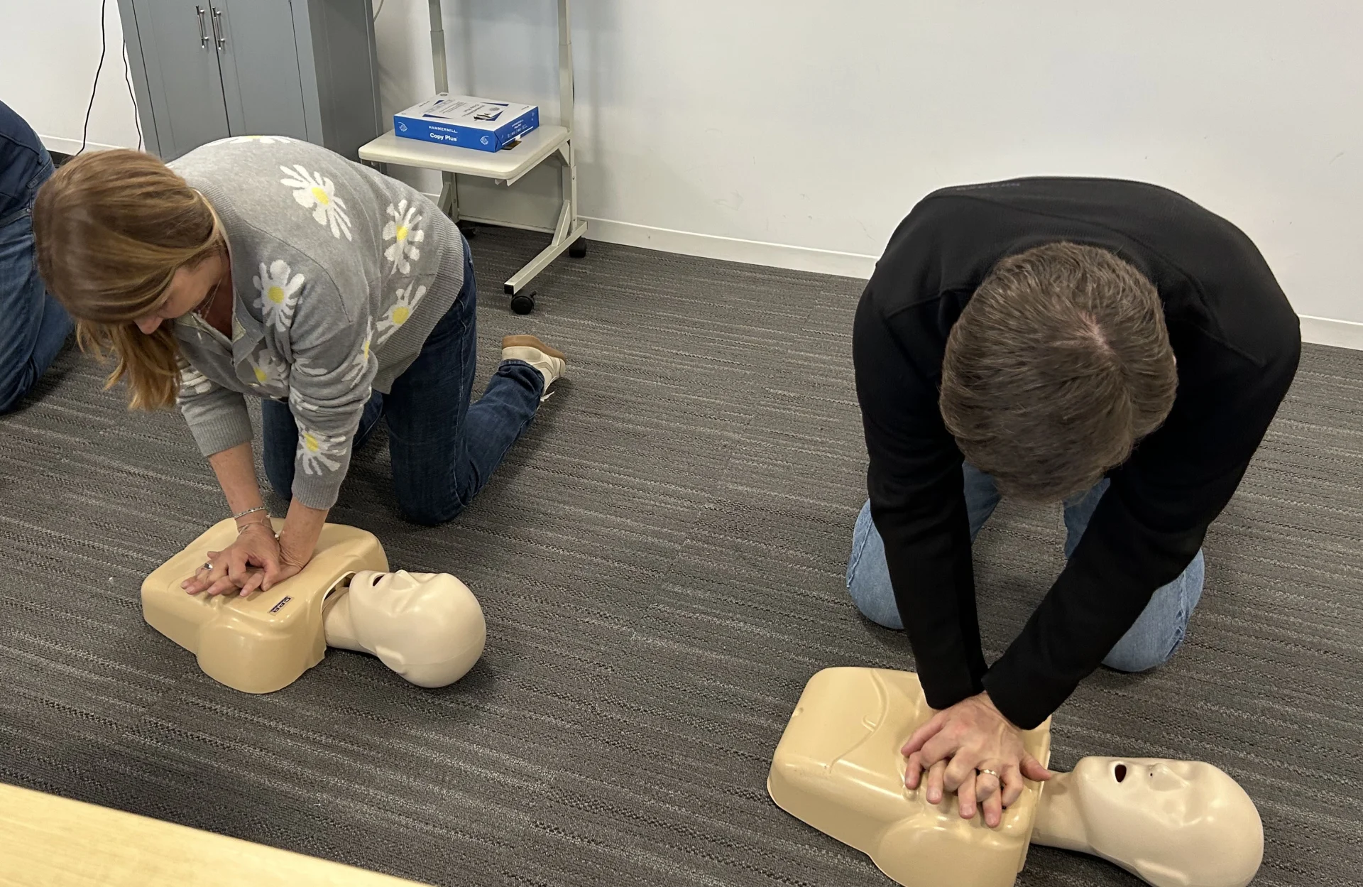 employees performing CPR on practice dummies